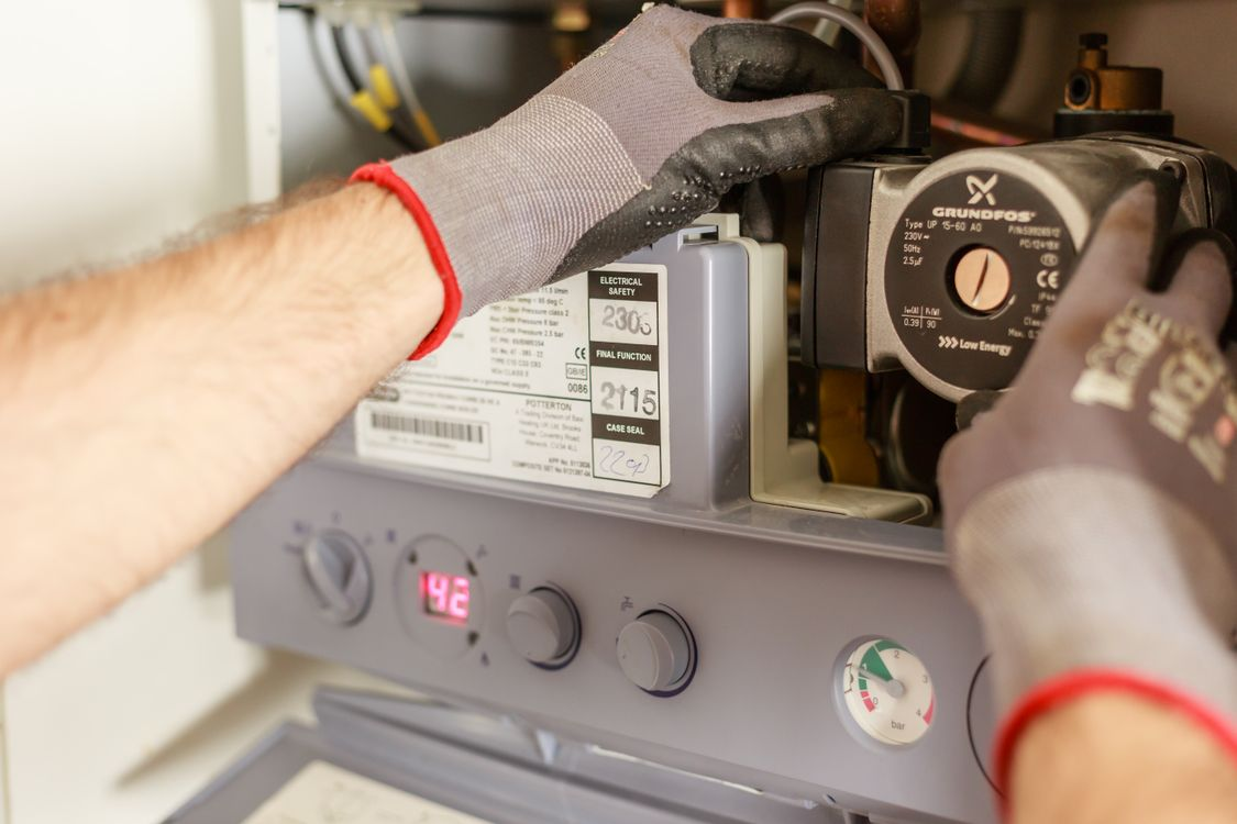 Gas Safe engineer servicing a combi boiler during a Doncaster boiler installation by Radiant Heating Yorkshire