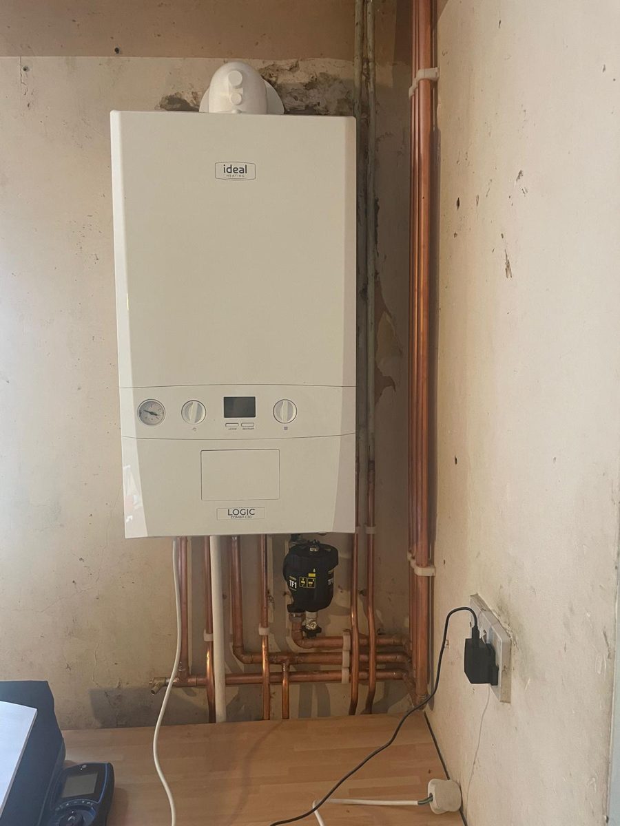 Newly installed Ideal combi boiler with neat copper pipework below